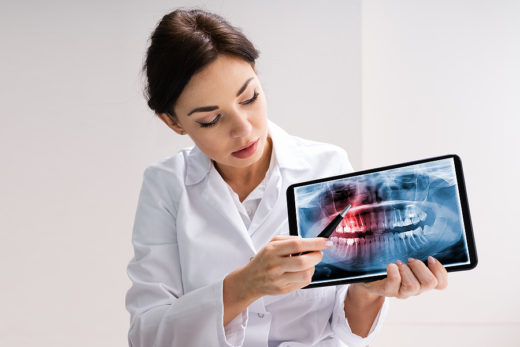 Amazing Growth and Benefits of Teledentistry: A Dentist Using Tablet Technology for Dental Care Concept.